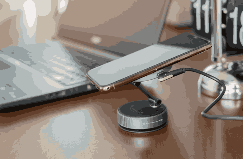 Compact 10000mAh power bank charging smartphone on desk
